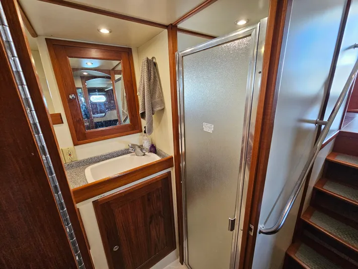 Good Job Yacht Photos Pics 2002 Nordhavn Trawler bathroom with wooden cabinetry, sink, and shower.