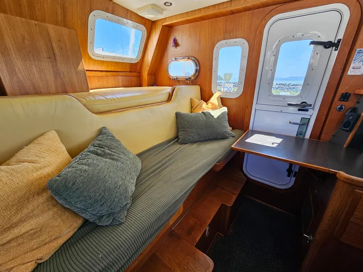 Good Job Yacht Photos Pics Interior of 2002 Nordhavn Trawler with cozy seating and wooden accents.