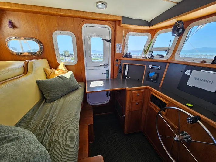 Good Job Yacht Photos Pics Cozy 2002 Nordhavn Trawler interior with helm, seating, and navigation equipment.