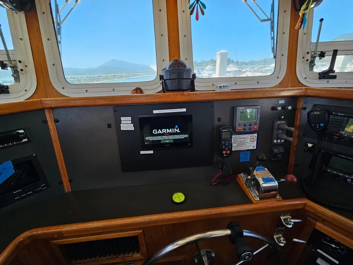 Good Job Yacht Photos Pics 2002 Nordhavn Trawler helm with Garmin navigation system and ocean view through windows.