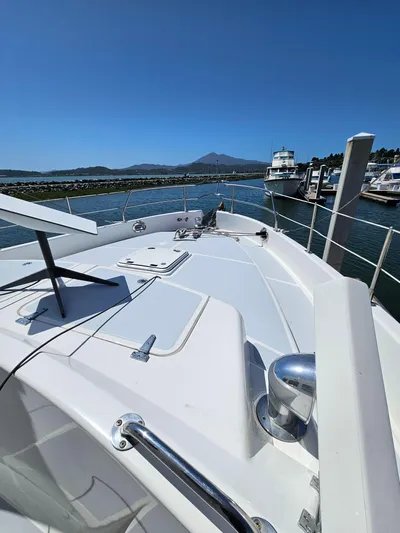 Good Job Yacht Photos Pics 2002 Nordhavn Trawler on water, docked at marina with clear blue sky.