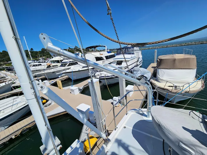 Good Job Yacht Photos Pics 2002 Nordhavn Trawler docked at marina, surrounded by other boats under clear blue sky.