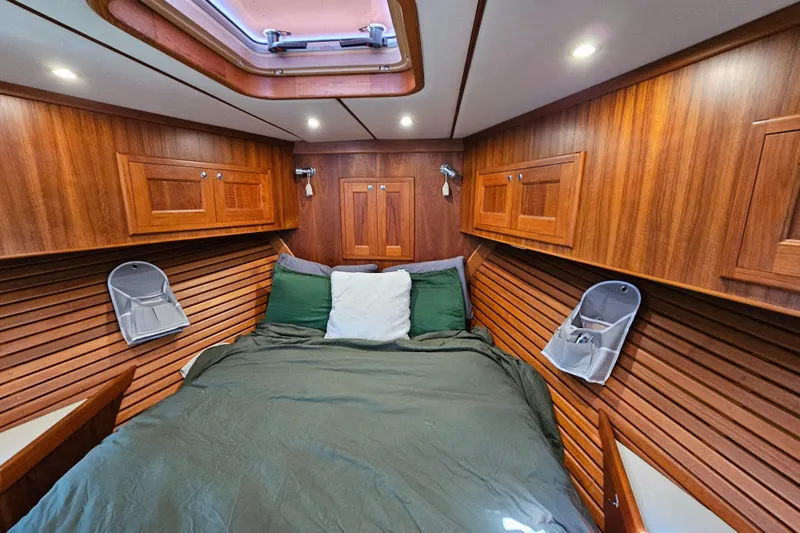 Good Job Yacht Photos Pics Cozy cabin interior of a 2002 Nordhavn Trawler with wood paneling and a skylight.