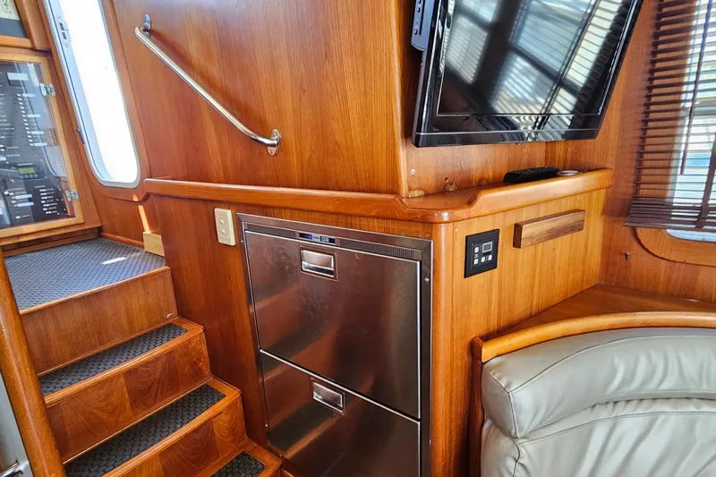 Good Job Yacht Photos Pics Interior of 2002 Nordhavn Trawler with wooden paneling, stairs, and built-in appliances.