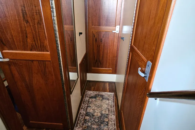 Good Job Yacht Photos Pics Hallway inside 2002 Nordhavn Trawler with wooden doors and decorative rug.
