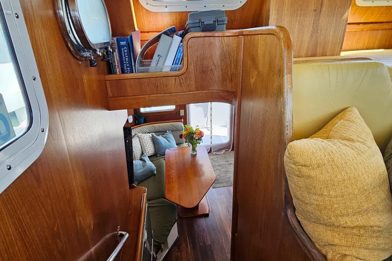 Good Job Yacht Photos Pics Interior of a 2002 Nordhavn Trawler with wooden furnishings and cozy seating area.