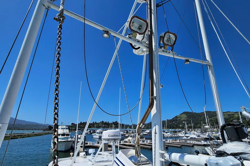 Good Job Yacht Photos Pics 2002 Nordhavn Trawler in marina, clear blue sky, masts and equipment visible.