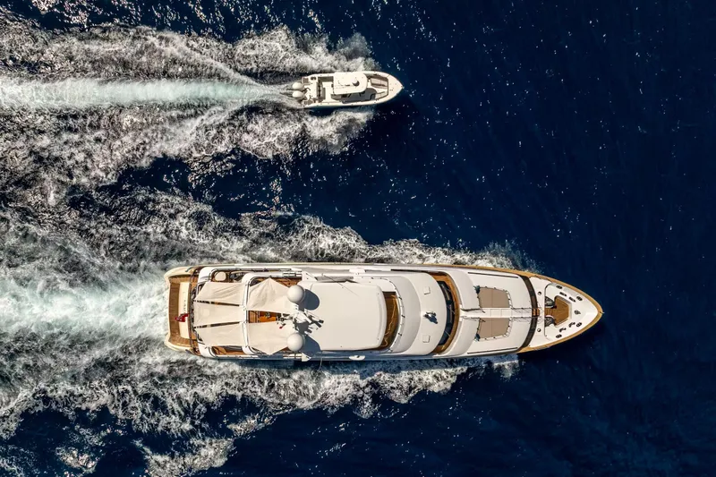 Lady H Yacht Photos Pics Aerial view of 2011 Benetti Majesty 120 yacht cruising with a smaller boat nearby.