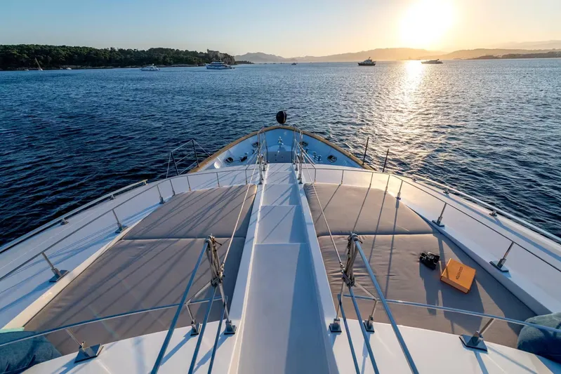 Lady H Yacht Photos Pics Bow view of 2011 Benetti Majesty 120 yacht at sunset on calm waters.