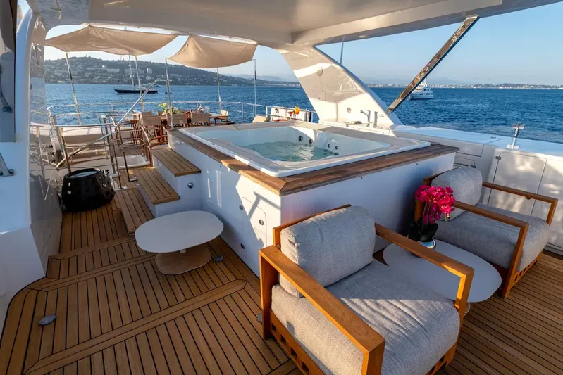 Lady H Yacht Photos Pics Luxurious Benetti Majesty 120 yacht deck with jacuzzi and seating, overlooking serene ocean view.