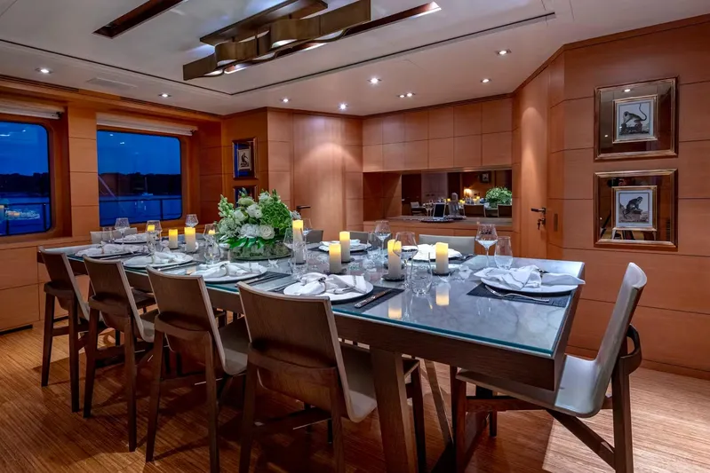 Lady H Yacht Photos Pics Luxurious dining area on 2011 Benetti Majesty 120 yacht, featuring elegant table setting and ambient lighting.