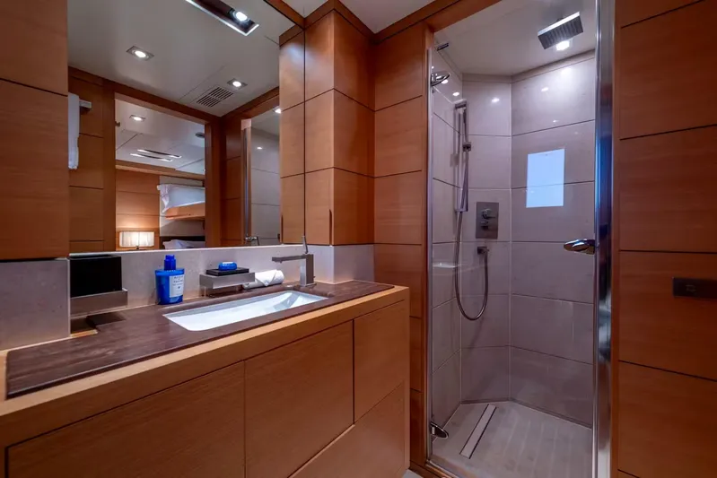 Lady H Yacht Photos Pics Luxurious bathroom on 2011 Benetti Majesty 120 yacht with modern shower and wooden cabinetry.