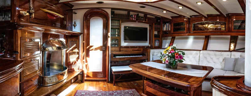 Whitefin Yacht Photos Pics Luxurious 1983 Renaissance Yachts sloop interior with elegant wood finish and plush seating.