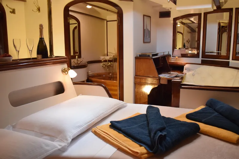 Whitefin Yacht Photos Pics Luxurious interior of 1983 Renaissance Yachts New Classic Sloop with elegant furnishings and cozy bedding.