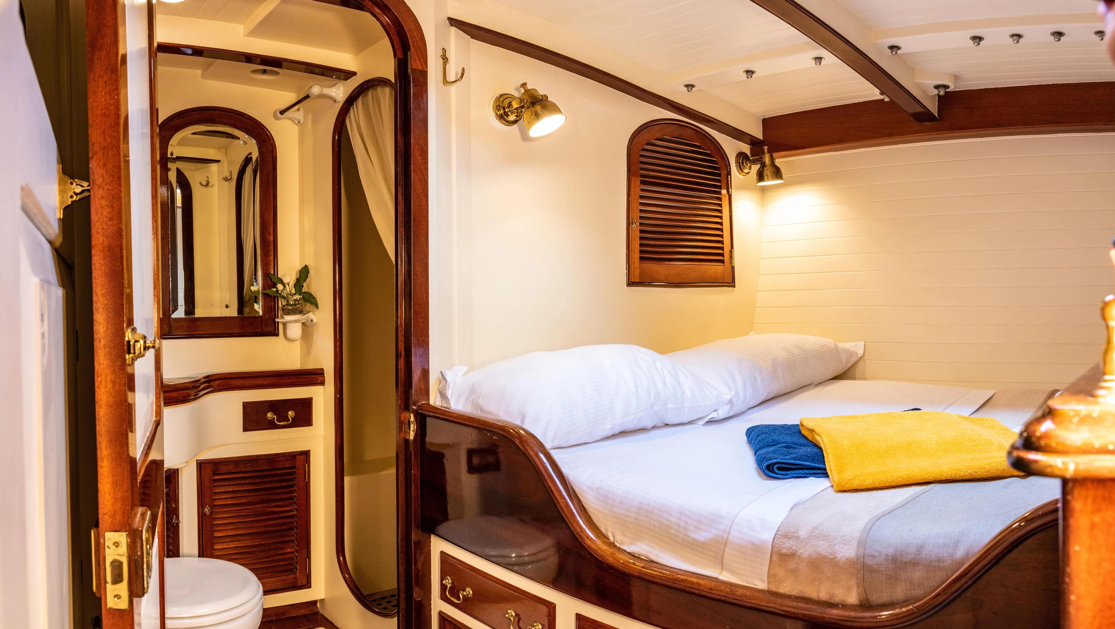 Whitefin Yacht Photos Pics Luxurious 1983 Renaissance Yachts sloop cabin with cozy bed and elegant wooden interior.
