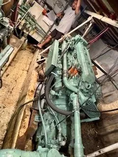 Atlantis Yacht Photos Pics Engine room of 1986 Drift Fishing Party boat with visible machinery and person standing.