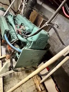 Atlantis Yacht Photos Pics Engine room of 1986 Drift Fishing Party boat, featuring a green marine engine.