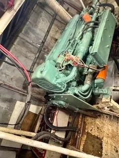 Atlantis Yacht Photos Pics Engine room of 1986 Commercial Drift Fishing Party boat, featuring a green engine and wiring.