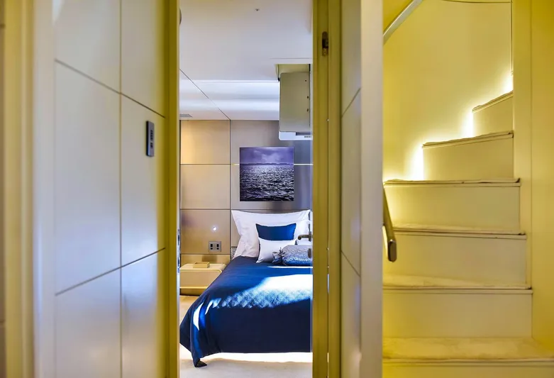  Yacht Photos Pics Luxurious Admiral 36 yacht interior, featuring a cozy bedroom and illuminated staircase, 2007 model.