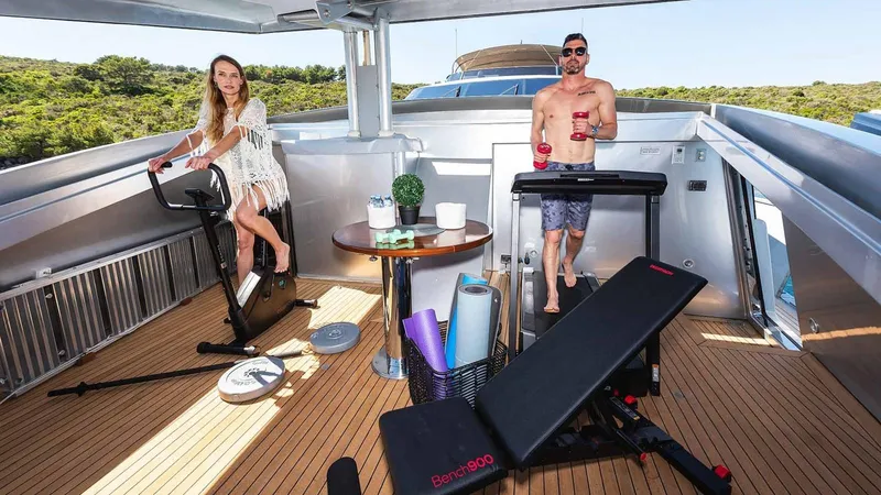  Yacht Photos Pics Couple exercising on yacht deck with fitness equipment, Admiral 36, 2007 model.