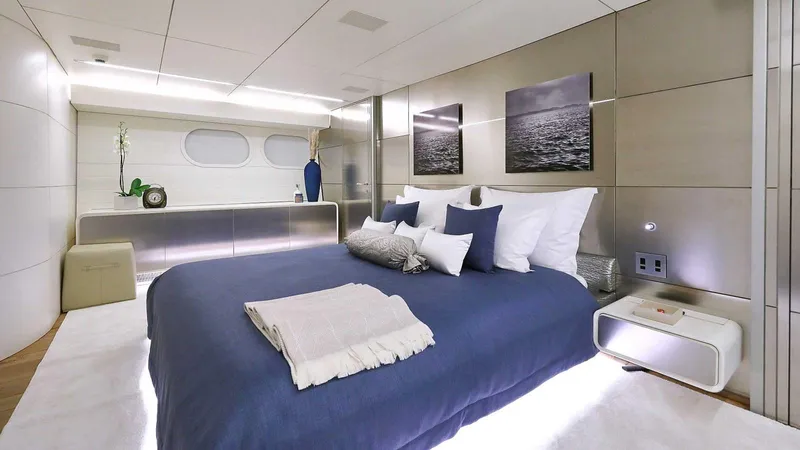  Yacht Photos Pics Luxurious yacht bedroom with modern decor, blue bedding, and elegant lighting, Admiral 36, 2007 model.