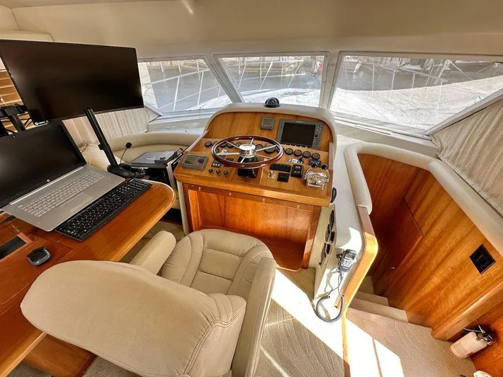 Backdraft Yacht Photos Pics Helm station of 2007 Navigator 5400 yacht with steering wheel, controls, and navigation equipment.