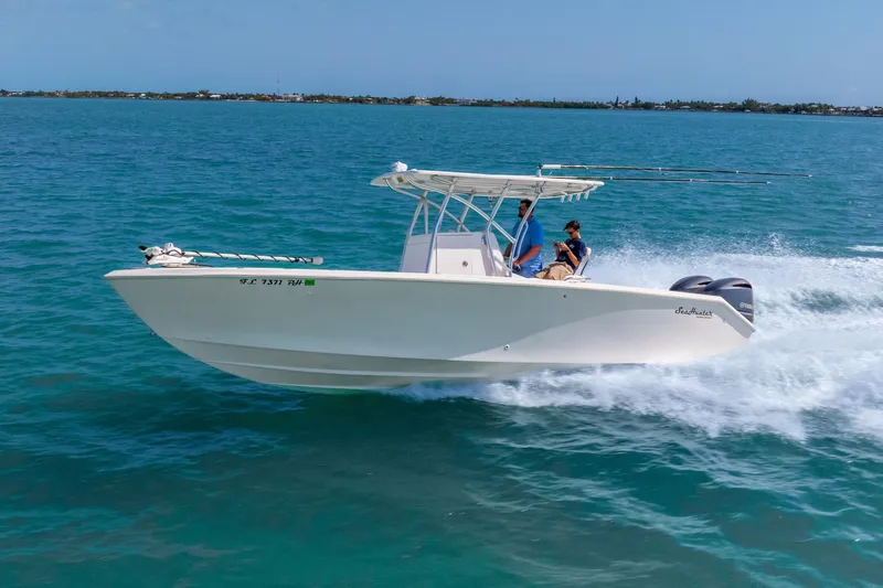  Yacht Photos Pics 2012 SeaHunter 29 boat cruising on clear blue water with two people onboard.