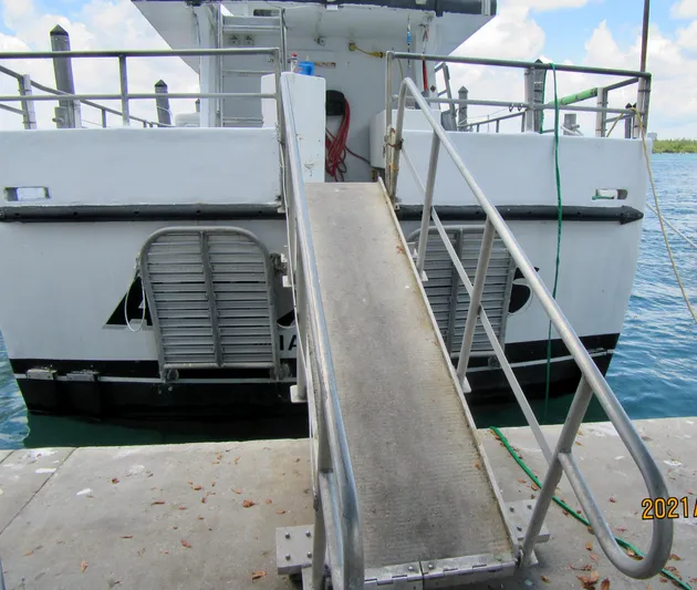 Atlantis Yacht Photos Pics Commercial drift fishing boat with ramp, docked at a pier, 1986 model.