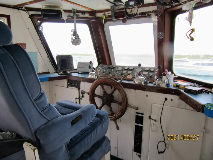 Atlantis Yacht Photos Pics Interior of 1986 Drift Fishing Party boat cockpit with steering wheel and control panel.