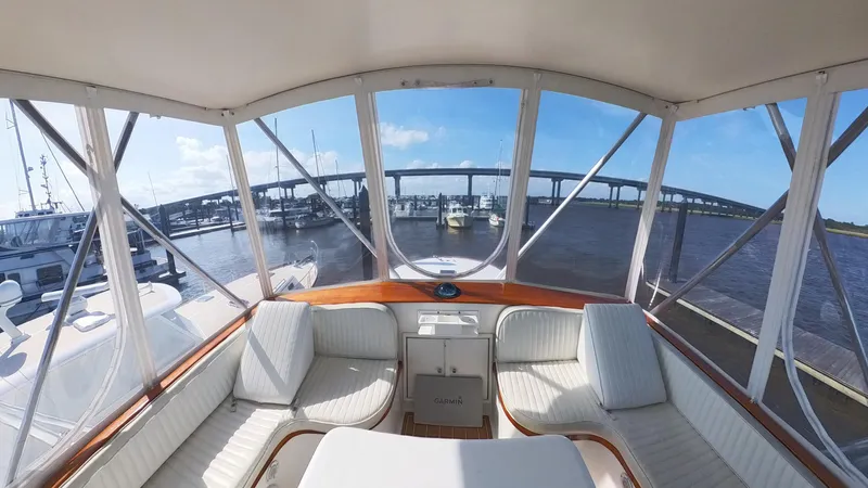  Yacht Photos Pics Interior view of 1990 Buddy Davis 47 SportFisherman yacht with marina and bridge in background.