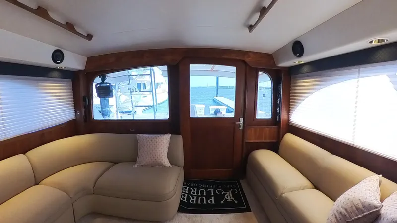  Yacht Photos Pics Interior of 1990 Buddy Davis 47 SportFisherman with beige seating and wooden accents.