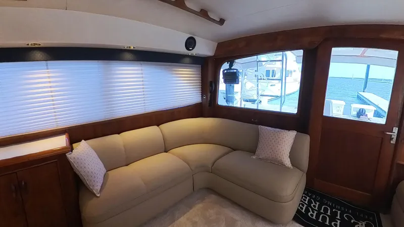  Yacht Photos Pics Luxurious interior of 1990 Buddy Davis 47 SportFisherman yacht with plush seating and scenic window view.