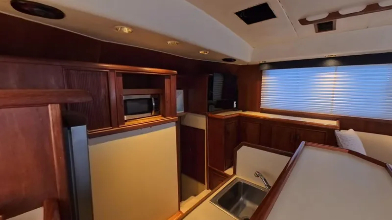  Yacht Photos Pics Interior of 1990 Buddy Davis 47 SportFisherman yacht with kitchen and wooden cabinetry.