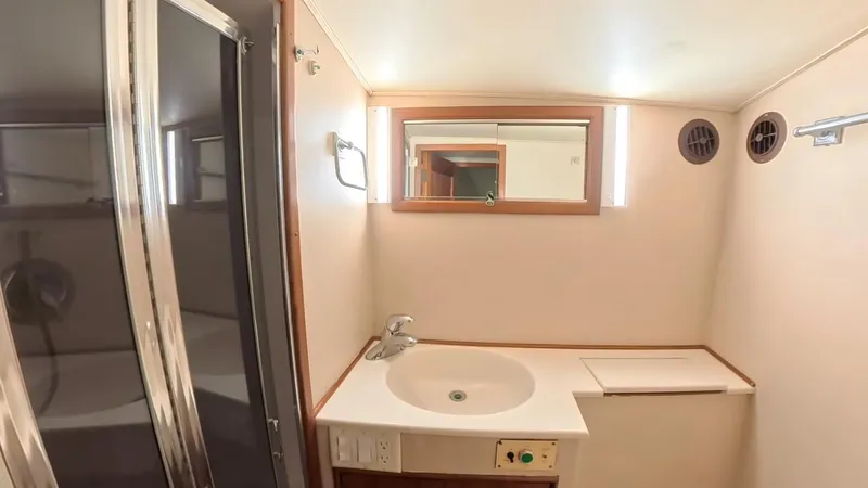  Yacht Photos Pics Bathroom interior of 1990 Buddy Davis 47 SportFisherman yacht, featuring sink and shower.