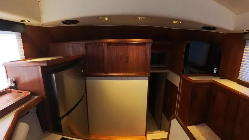  Yacht Photos Pics Interior of 1990 Buddy Davis 47 SportFisherman with wood cabinetry and stainless steel appliances.