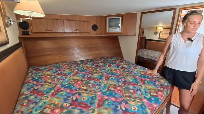  Yacht Photos Pics Cozy cabin interior of 1990 Buddy Davis 47 SportFisherman with colorful bedding.