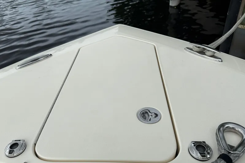 T/t B Happy Yacht Photos Pics 2019 Scout 320 LXF boat deck with cleats and hatch, near water.