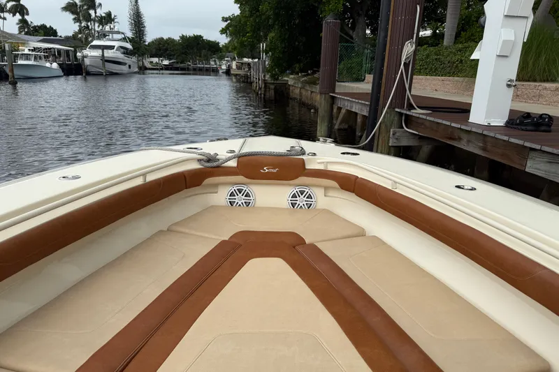 T/t B Happy Yacht Photos Pics 2019 Scout 320 LXF boat interior with tan and brown seating, docked by a canal.