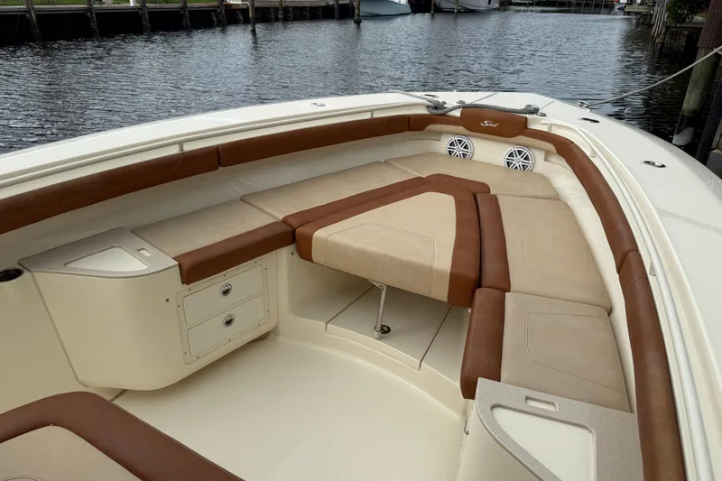 T/t B Happy Yacht Photos Pics 2019 Scout 320 LXF boat interior with cushioned seating and storage compartments.