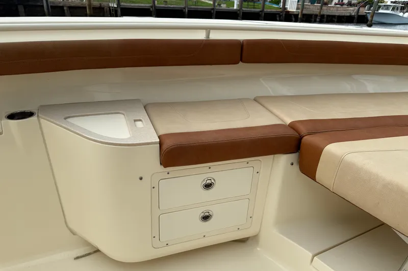 T/t B Happy Yacht Photos Pics 2019 Scout 320 LXF boat interior with brown and beige seating and storage compartments.
