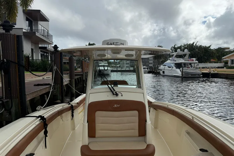T/t B Happy Yacht Photos Pics 2019 Scout 320 LXF boat docked in a marina with cloudy skies.