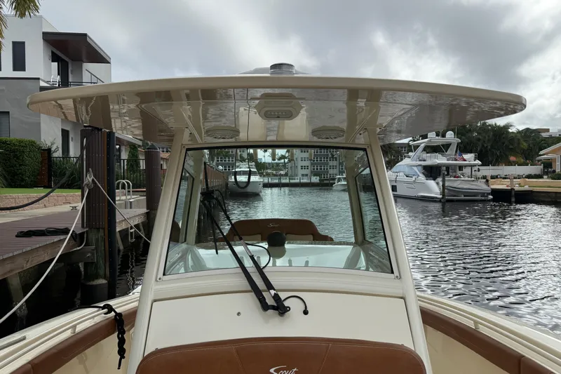 T/t B Happy Yacht Photos Pics 2019 Scout 320 LXF boat docked in a marina with waterfront homes.