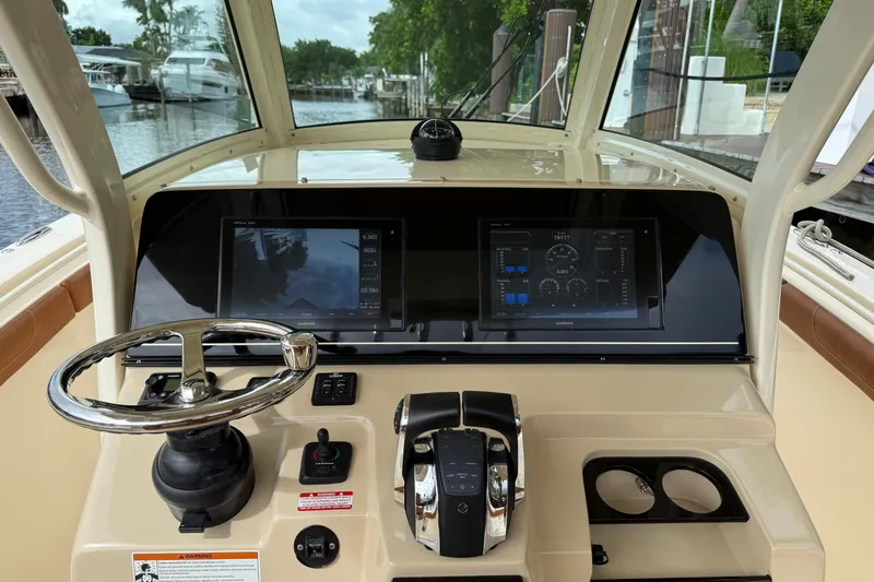 T/t B Happy Yacht Photos Pics 2019 Scout 320 LXF boat dashboard with steering wheel and digital displays.