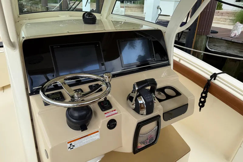T/t B Happy Yacht Photos Pics 2019 Scout 320 LXF boat helm with dual screens and steering wheel.