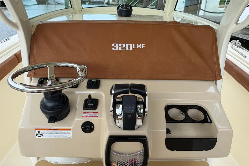 T/t B Happy Yacht Photos Pics 2019 Scout 320 LXF boat dashboard with steering wheel and controls.