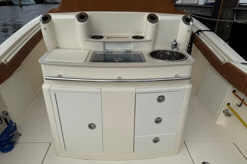T/t B Happy Yacht Photos Pics 2019 Scout 320 LXF boat interior with sink, storage, and seating.