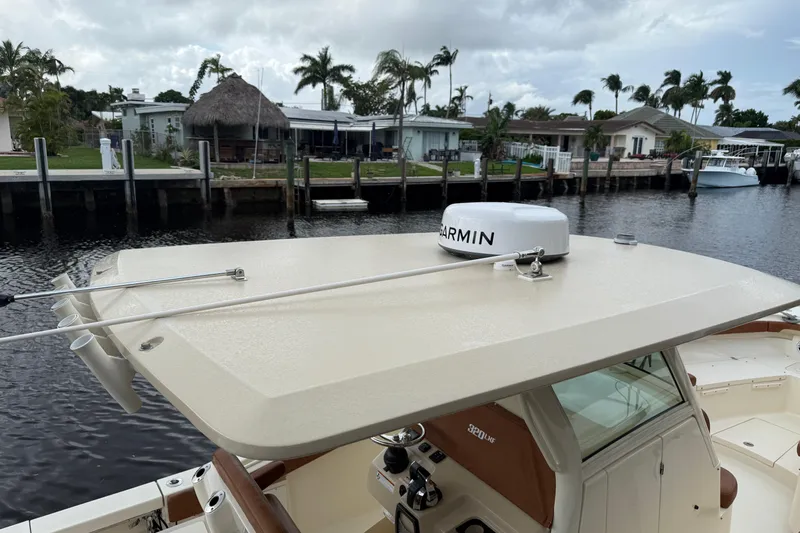 T/t B Happy Yacht Photos Pics 2019 Scout 320 LXF boat with Garmin radar, docked near waterfront homes.