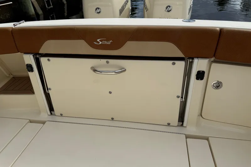 T/t B Happy Yacht Photos Pics 2019 Scout 320 LXF boat interior with storage compartment and brown seating.