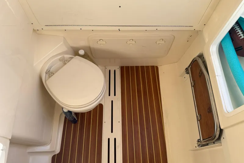 T/t B Happy Yacht Photos Pics 2019 Scout 320 LXF boat interior with toilet and wooden flooring.