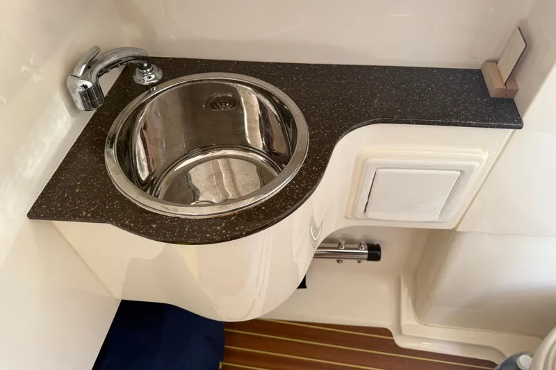 T/t B Happy Yacht Photos Pics 2019 Scout 320 LXF boat interior with stainless steel sink and faucet.